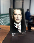 Atatürk 111 Cam Tablo on a desk, showcasing its elegant design and high-quality glass material.