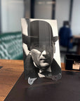 Atatürk 127 Cam Tablo on a desk, featuring a high-quality tempered glass design with a classic black and white photo.