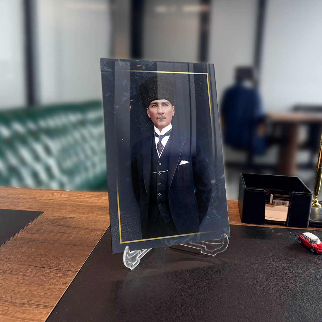 Atatürk glass art piece on a desk, showcasing high-quality UV printing in an elegant office setting.