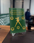 Barbaros Hayrettin Paşa Sancağı Cam Tablo with decorative symbols in gold on a green background.