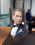 Elegant man in a tuxedo displayed on a glass stand in a stylish office setting.