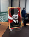 Atatürk 245 Cam Tablo with UV printing, framed by Turkish flag design, showcased in a modern office setting.