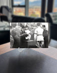 Historical black and white photo of officials in Ankara discussing at a table, showcasing Atatürk's era.