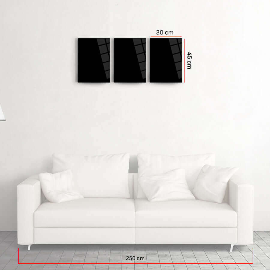 Black glass triptych art above a white couch, dimensions 30x45 cm per panel, modern home decor.