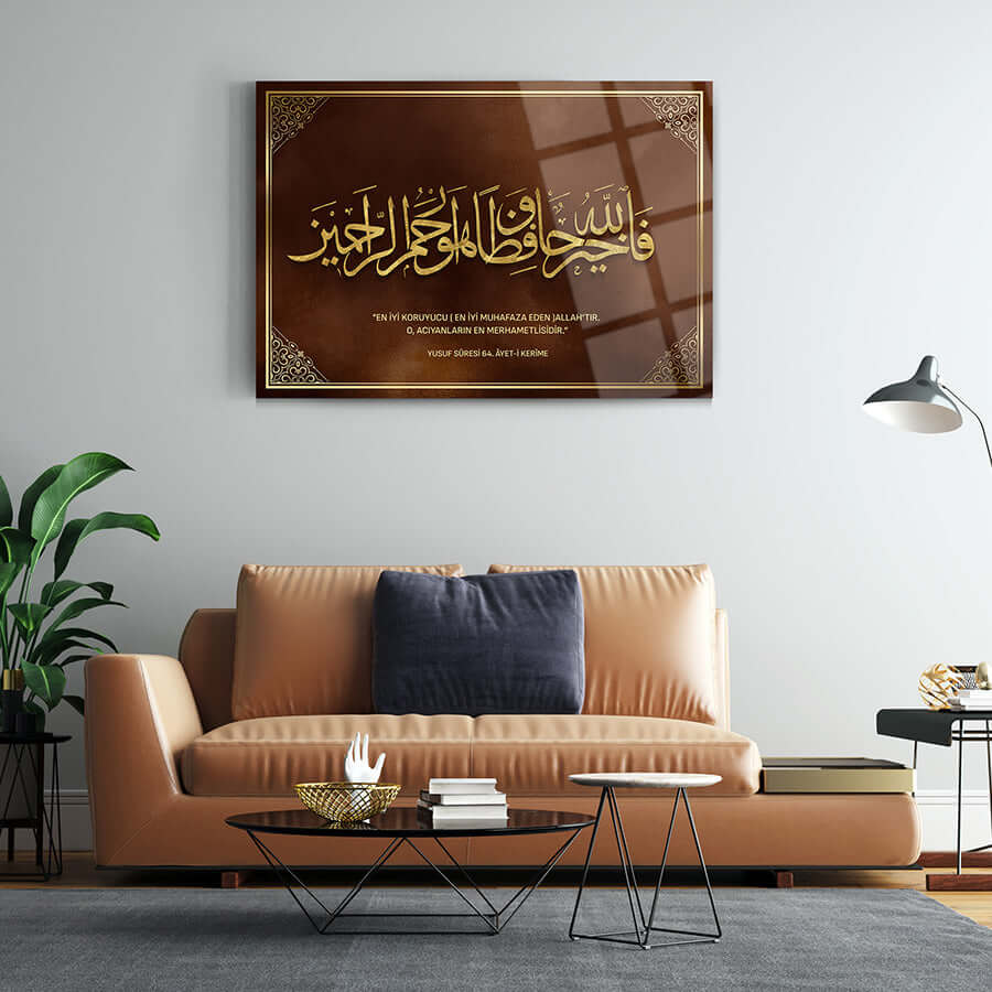 Yusuf Suresi 64. Ayet 2 gold calligraphy glass art on a modern living room wall.