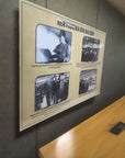 Framed display with historical factory photographs and quotes on a wall.