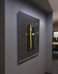 Decorative wall art with a yellow arrow on a patterned black background in a modern office setting.