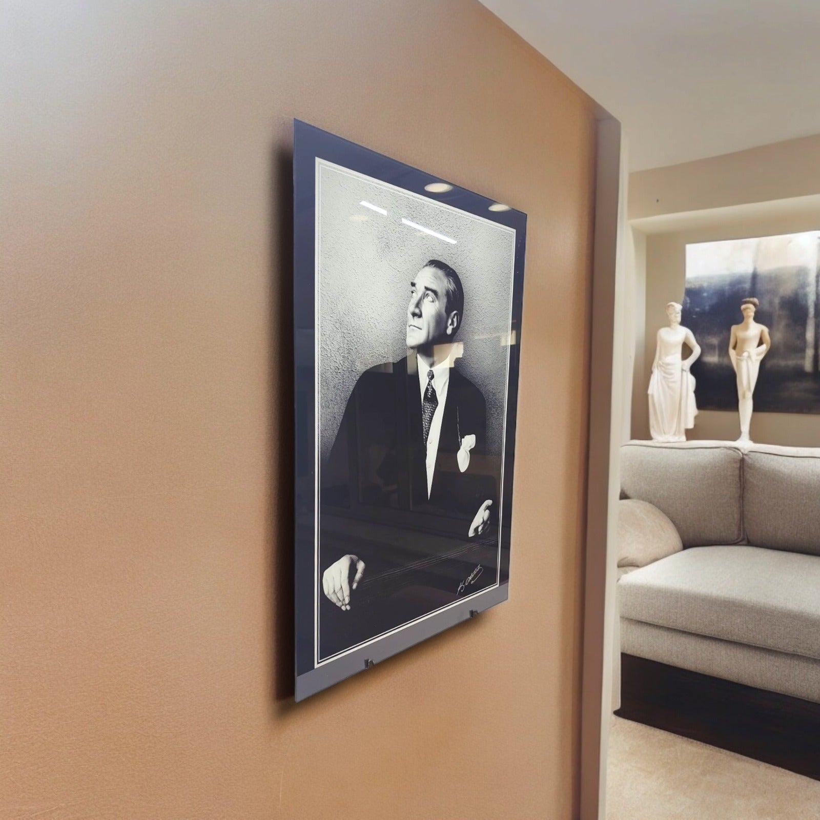 Elegant black and white portrait framed on a wall in a modern living room setting.