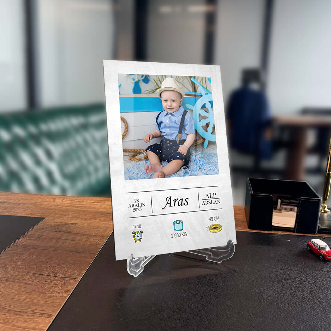 Personalized photo frame display featuring a smiling baby boy named Aras in a stylish setting.