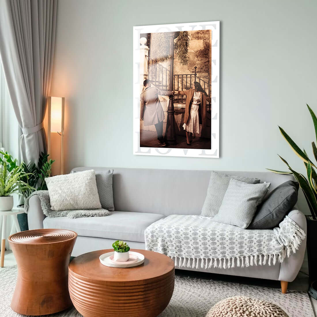 Modern living room featuring a stylish glass artwork on the wall, cozy seating and decorative plants.