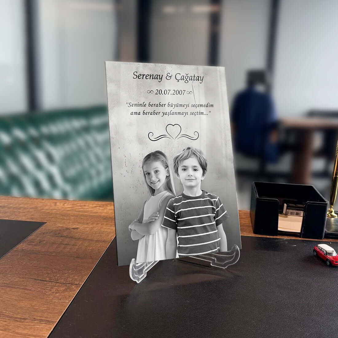 Kişiye özel tasarım cam tablo, kişisel mesaj ve fotoğraf detaylarıyla, modern ofis dekorasyonu için ideal.