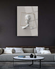 Modern artistic wall decor featuring a mannequin with a golden frame in a stylish living room setting.