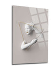 Modern artistic wall art featuring a sculpted figure in a triangle frame on a soft background.