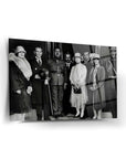 Historical black and white photo of a formal gathering outside a building, featuring several elegantly dressed individuals.