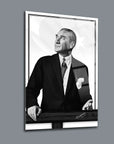Black and white portrait of a distinguished man in a suit, featuring a Turkish flag background.