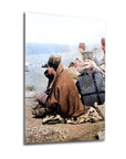 Historical photo of two individuals by the water, featuring traditional attire and cultural elements.