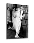 Black and white image of a couple dancing at a wedding, vintage style, with guests in the background.