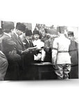 Historic black and white photo of Atatürk and officials at a signing ceremony in Ankara.