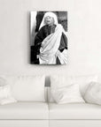 Black and white cam tablo featuring a person in traditional attire, displayed above a modern white couch.