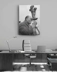 Black and white cam tableau featuring a man observing through a telescope, set in a modern office environment.