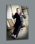 Elegant man in a suit swinging on a rustic wooden swing, captured in high-quality glass art.