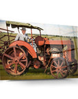 Vintage man with hat on old red tractor in a field, showcasing agricultural heritage and nostalgia.