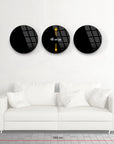 Modern geometric 3-piece black glass wall art set above a white sofa, measuring 48 cm each, 250 cm total width.