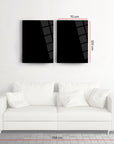 Modern black glass art set above a white couch, dimensions 70x100 cm each, stylish minimalist decor.