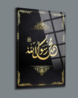 Elegant glass plaque with gold Arabic calligraphy of 'Allah'ın Resulü' on a dark background.