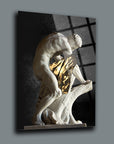 Modern artwork of a muscular sculpture with a gold draped piece, set against a contrasting background.