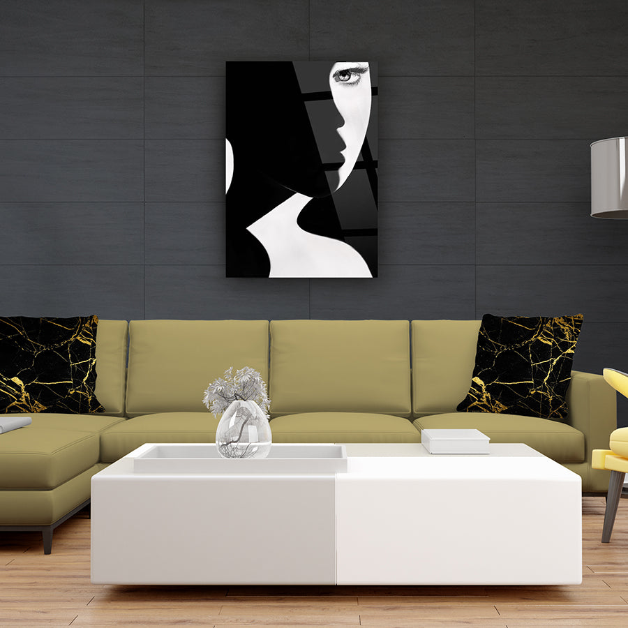 Modern living room with a black and white abstract art piece above a stylish sofa and table.