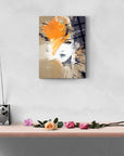 Artistic cam tablo on wall featuring abstract portrait with orange accents, elegant decor elements including flowers.
