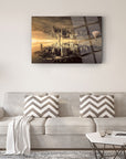 Modern cityscape glass art piece displayed in a decoratively styled living room with grey sofa and striped cushions.