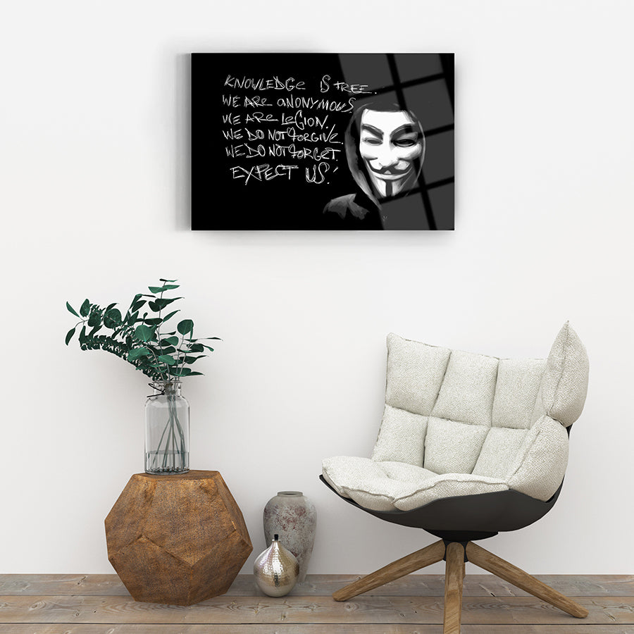 Canvas artwork featuring an iconic figure with text about anonymity and knowledge, set in a contemporary living space.