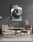 Monochrome eye art on glass table in modern living room with wooden furniture and stylish decor.