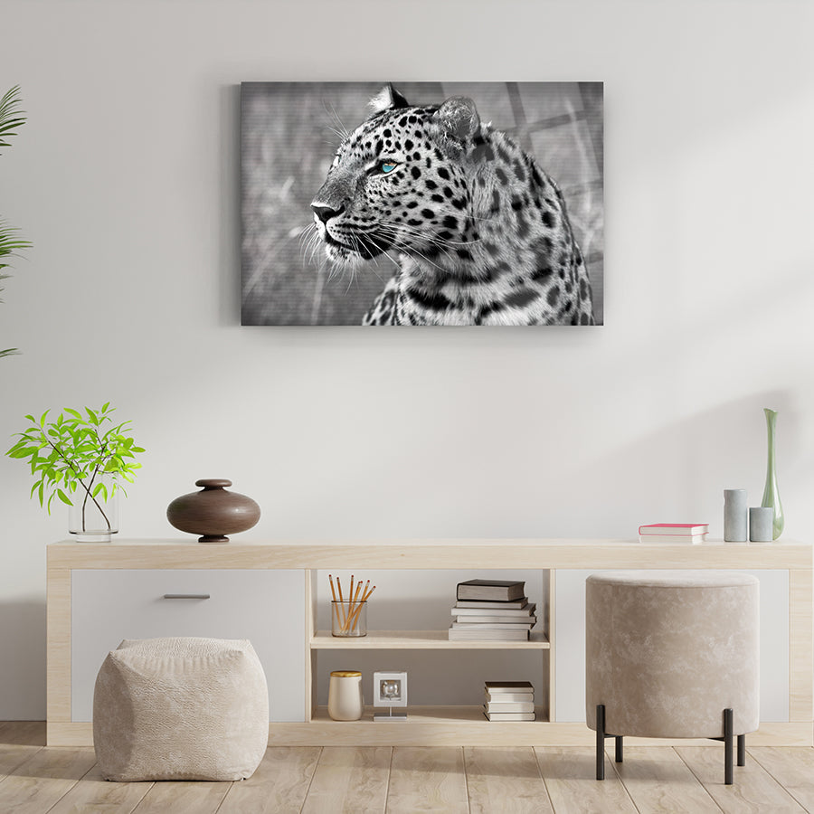 Black and white leopard portrait artwork displayed in a modern living room setting.