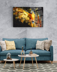 Vibrant Sarı Papağan Cam Tablo above a modern blue sofa in a stylish living room decor.