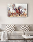 Colorful abstract painting of horses above a modern gray sofa in a cozy living room setting.