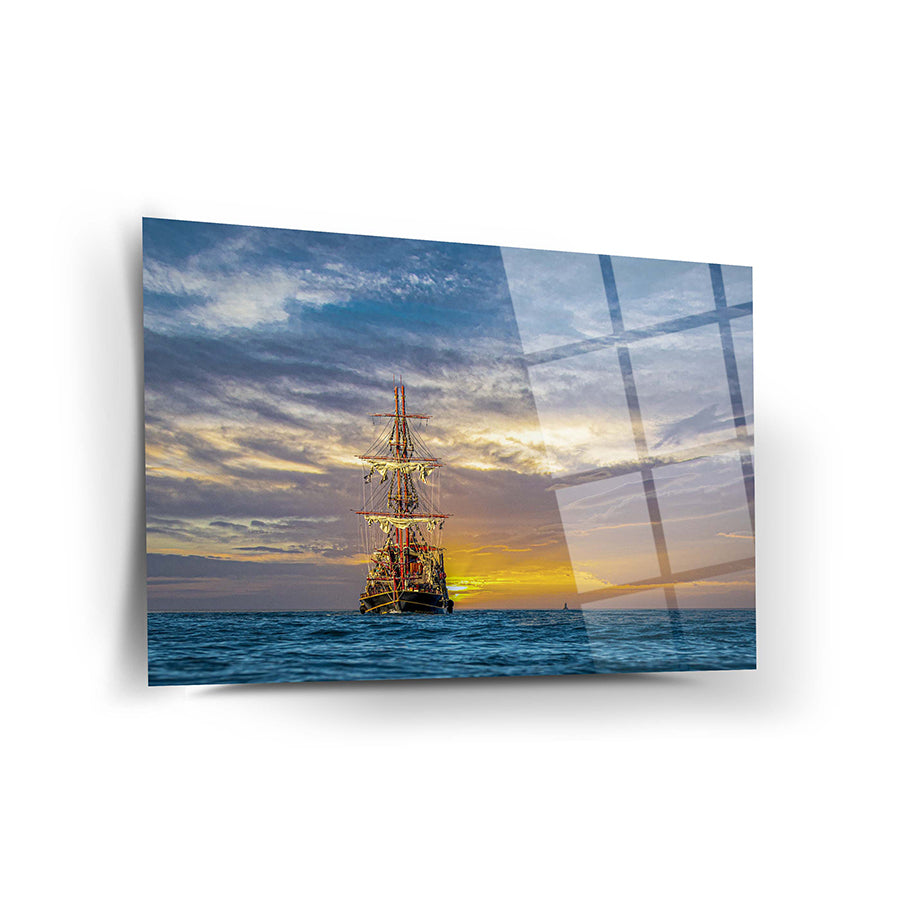 Ufuktaki Gemi Cam Tablo with sunset, showcasing a beautiful sailing ship on the ocean surface.