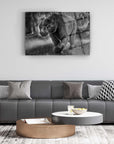 Black and white image of a panther artwork displayed above a modern gray sofa in a stylish living room setting.