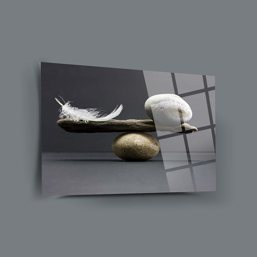 Denge Cam Tablo showcasing a feather and stones with a sleek design on a grey background.
