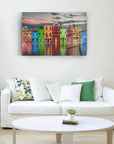 Colorful Burano Island houses reflected in water, displayed in modern living room with white sofa.
