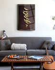 Modern living room featuring a stylish SRD Concept glass art piece above a cozy sofa with a coffee table and guitar.