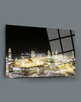 Beautiful night view of the Kaaba surrounded by pilgrims in an elegant glass frame.