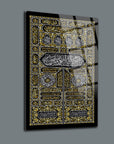 Elegant glass wall art featuring intricate gold and black Islamic calligraphy design.