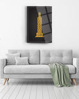 Chic Kufi Bağışla Allahım cam tablo above a modern gray sofa in a stylish interior setting.