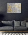 Elegant Nahl Suresi cam tablo on a modern wall above a stylish gray sofa, showcasing intricate gold lettering.