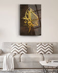 Elegant golden Arabic calligraphy canvas art displayed above a modern gray sofa in a stylish living room.