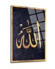 Elegant glass art featuring the Arabic calligraphy of Allah in golden lettering on a dark background.
