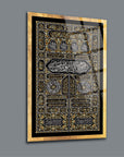 Elegant glass artwork featuring intricate Islamic calligraphy design with gold accents on a sleek background.